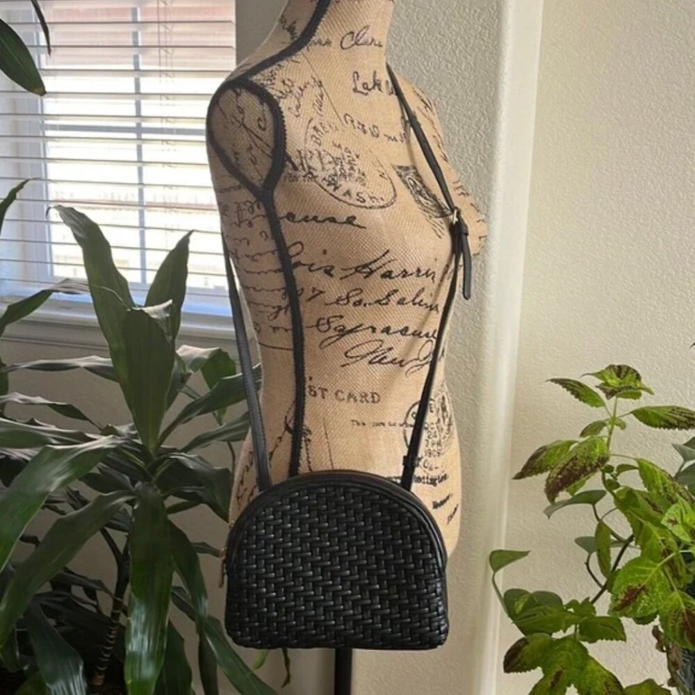 Anthropologie Woven crossbody black leather bag with adjustable crossbody strap.
